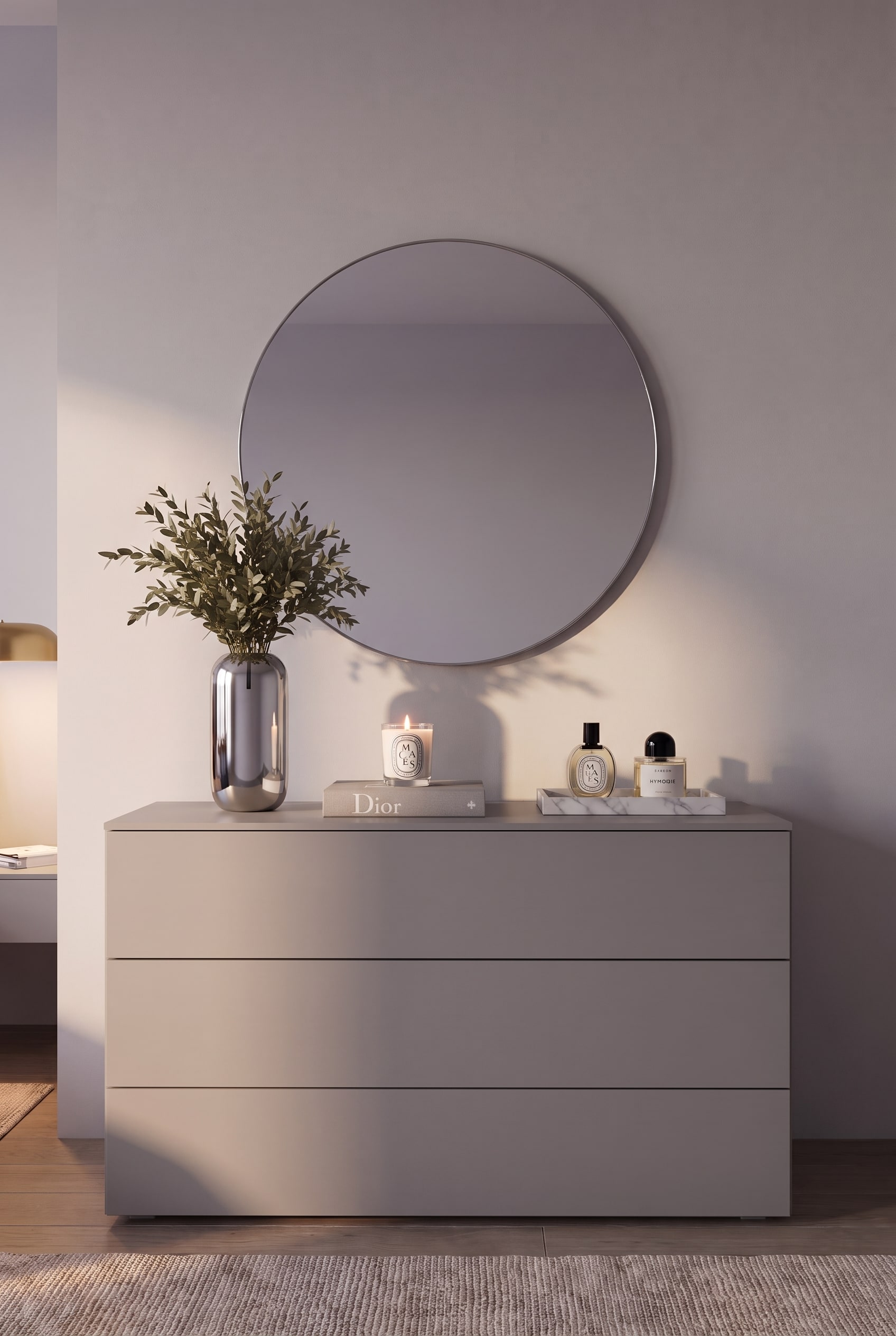 Gros plan frontal d'une commode sans poignées en gris mat avec trois tiroirs et une décoration discrète.