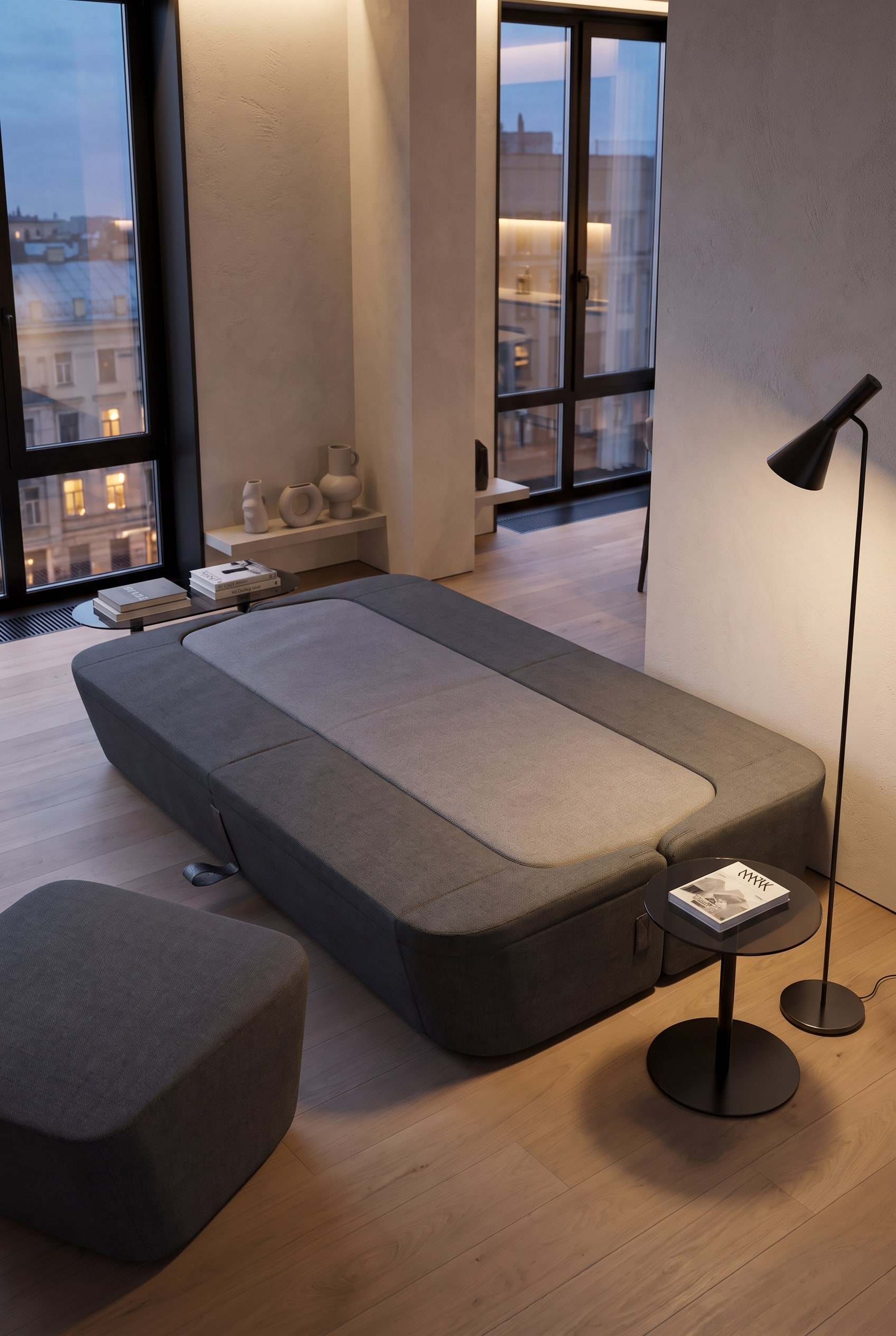 Salon minimaliste avec canapé-lit design gris et lampadaire élégant