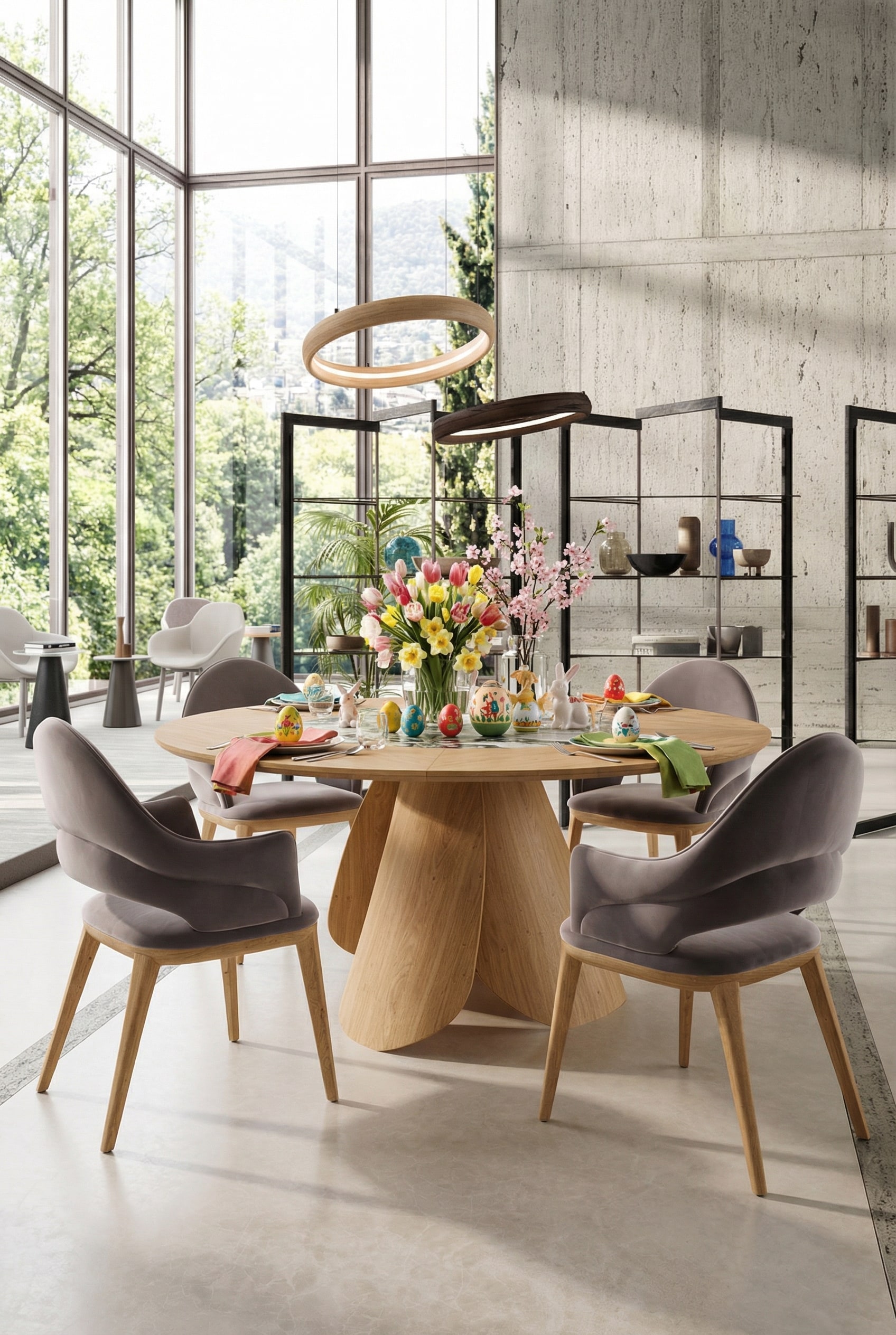 Table &agrave; manger ronde Ozzio Veliero en bois clair dans une salle &agrave; manger d'architecte baign&eacute;e de lumi&egrave;re