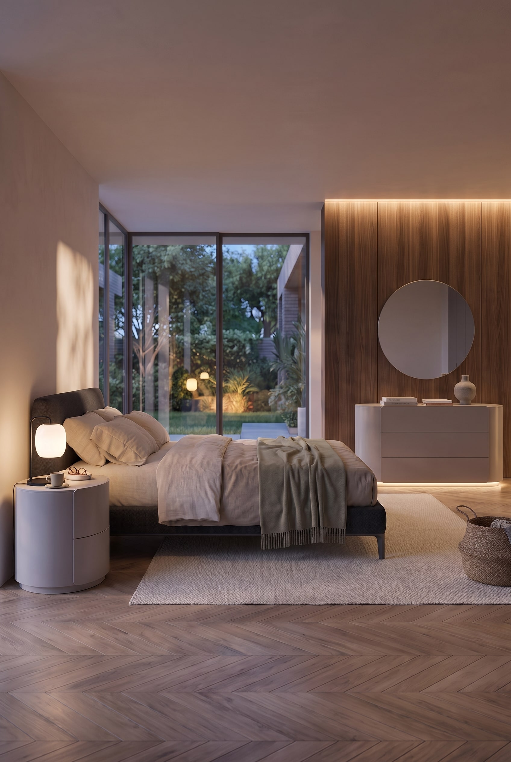 Chambre moderne en plan large, montrant une table de chevet ronde, un lit et une commode arrondie devant des panneaux de bois.