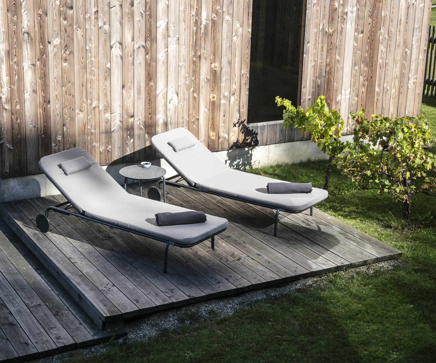 Todus Starling Design tuinstoel in duo op de houten veranda met witte stoffen bekleding