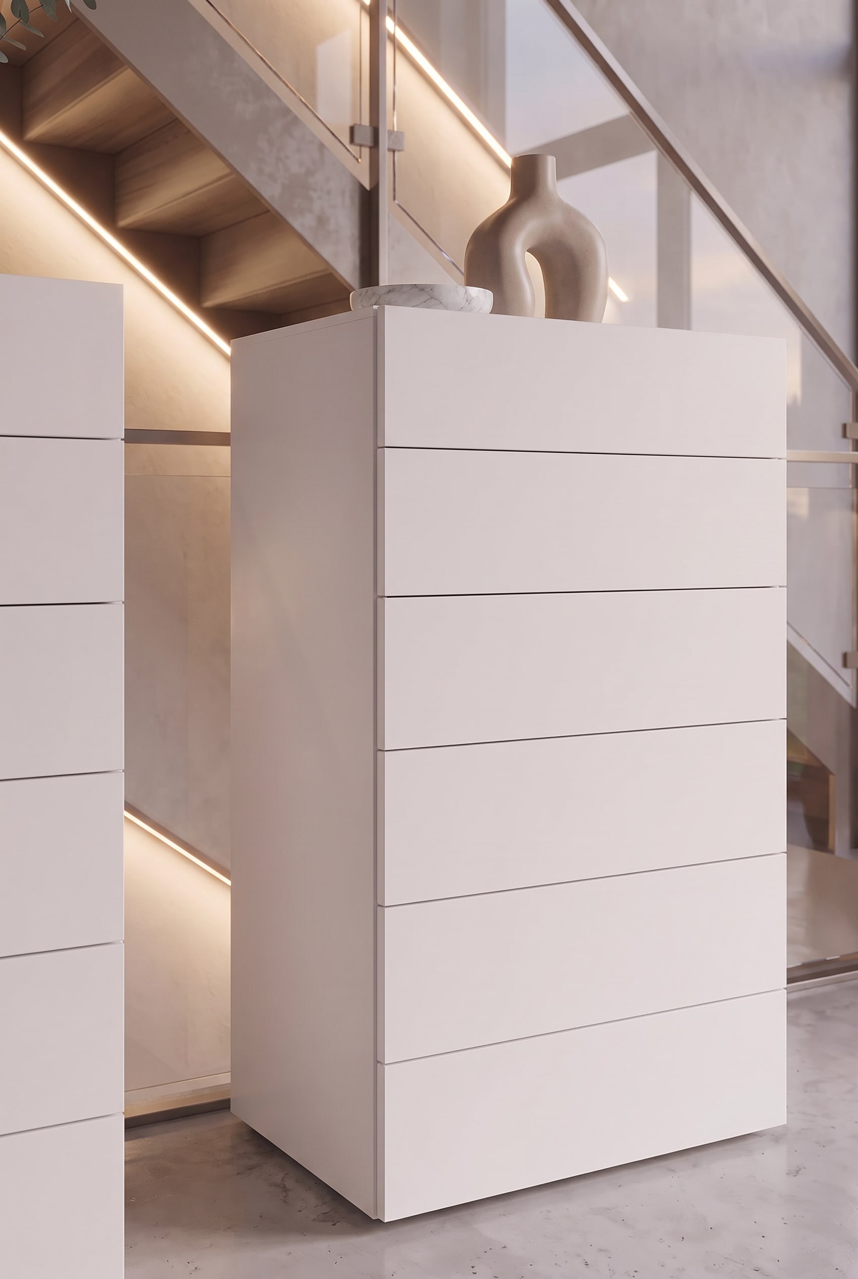 Vue détaillée d'une commode haute blanche avec tiroirs sans poignée et joint d'ombre fin.