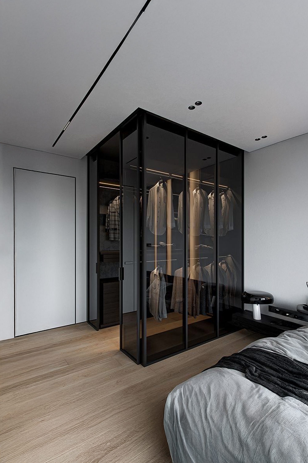 armoire-foncee-avec-portes-transparentes-a-cote-d-un-lit